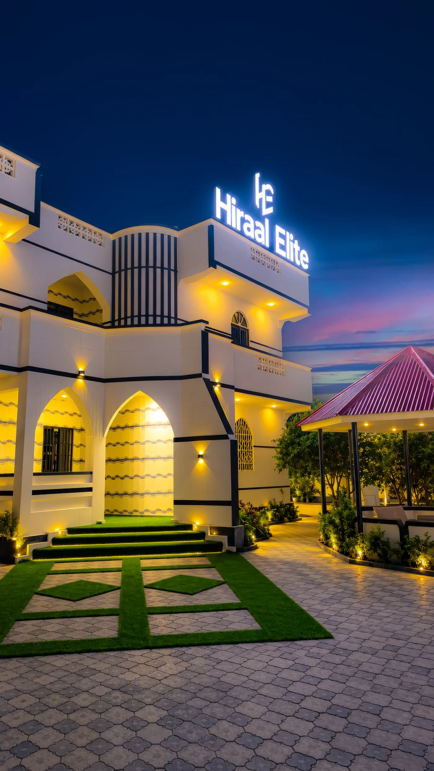 The Hiraal Elite building in Hargeisa at night, its illuminated sign above the entrance
